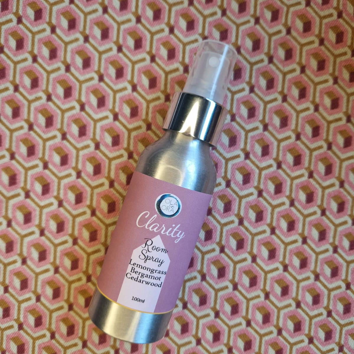 Aromatherapy Room Spray bottle labeled 'Clarity' on a pink geometric patterned background