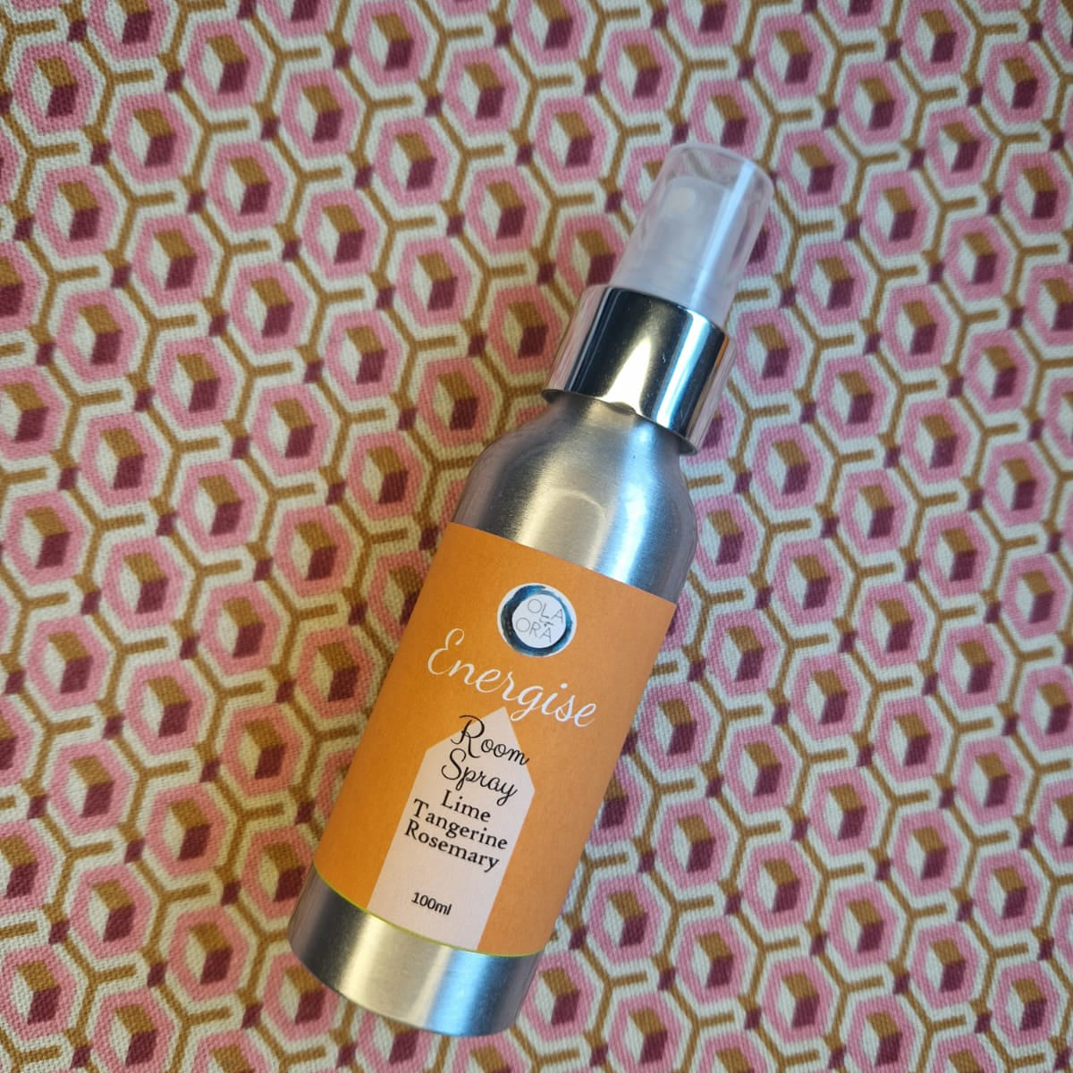 aromatherapy room spray bottle labeled 'Energise' on a patterned background