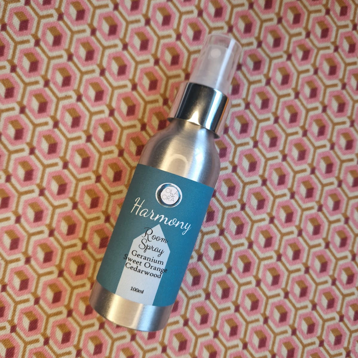 Harmony essential oil spray bottle on a patterned background