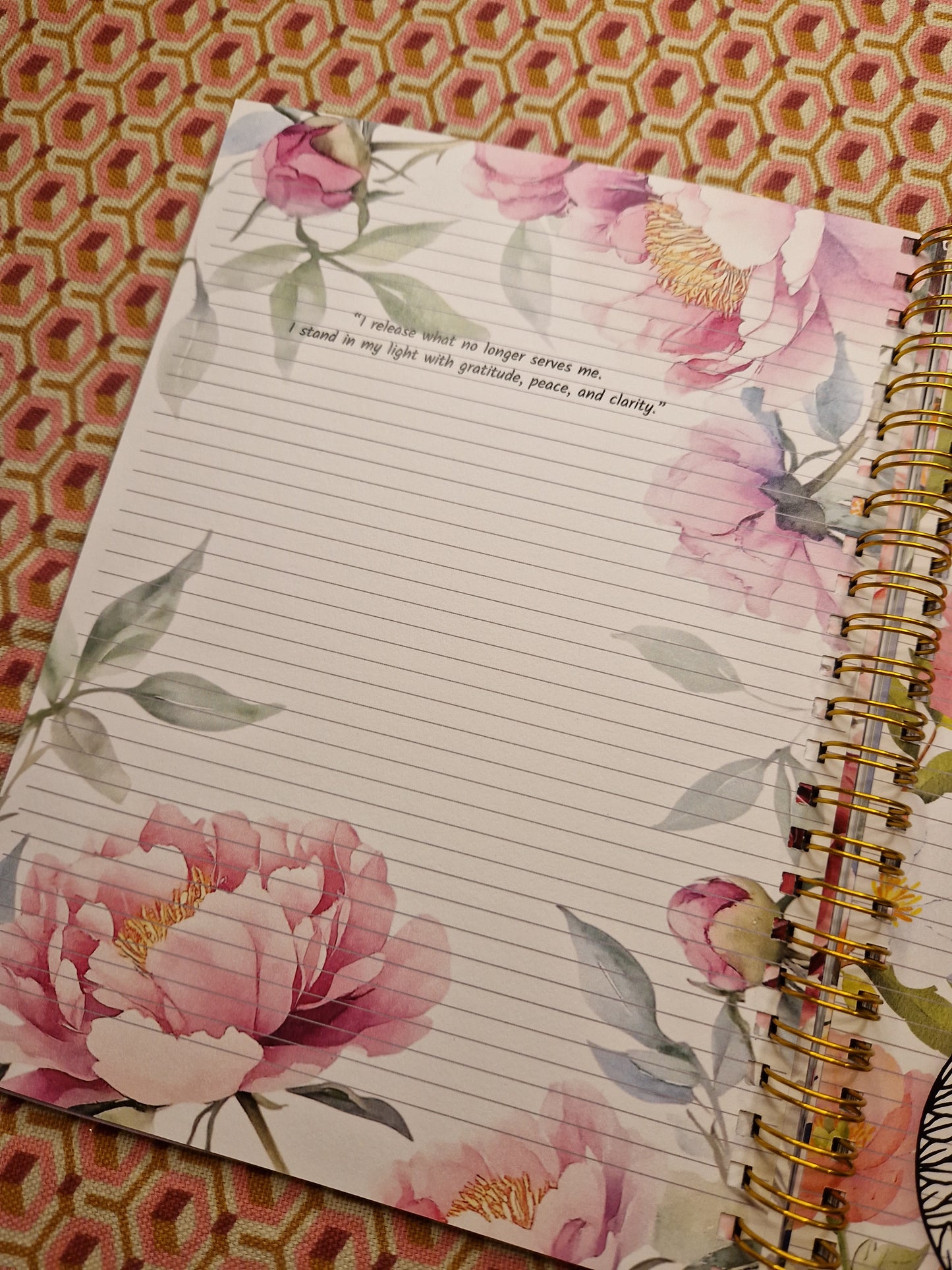 Floral notebook with lined pages on a patterned surface