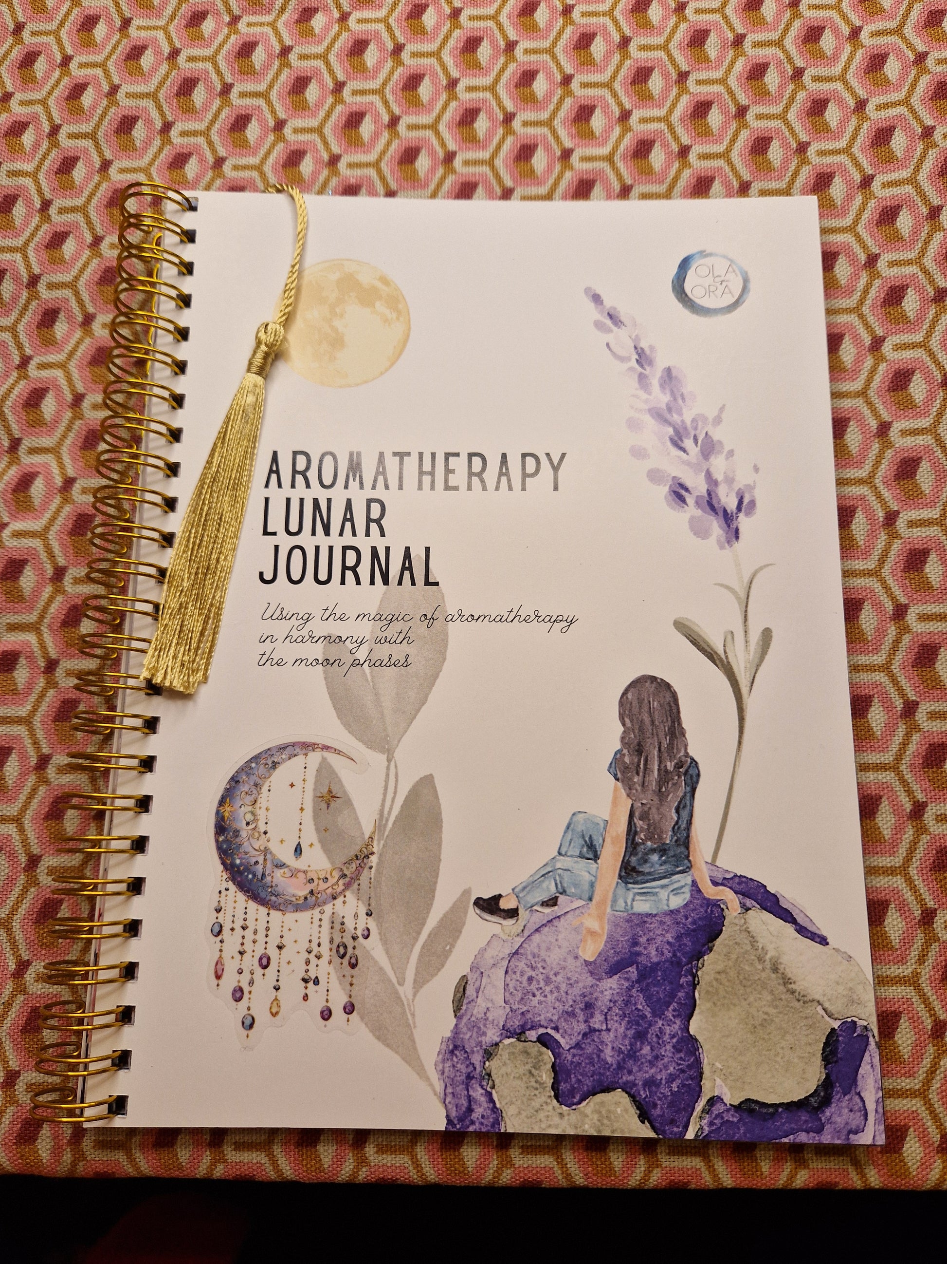 Aromatherapy lunar journal with artistic design on a patterned background