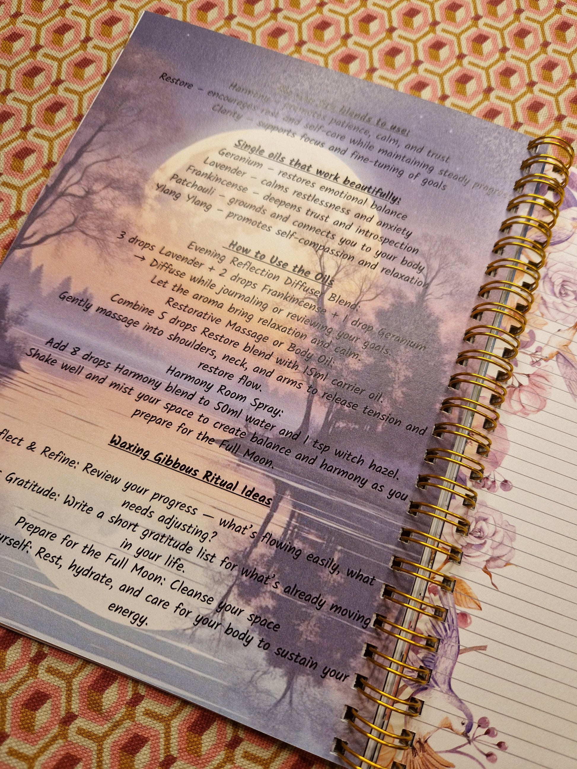 Open notebook with text and a decorative cover on a patterned surface