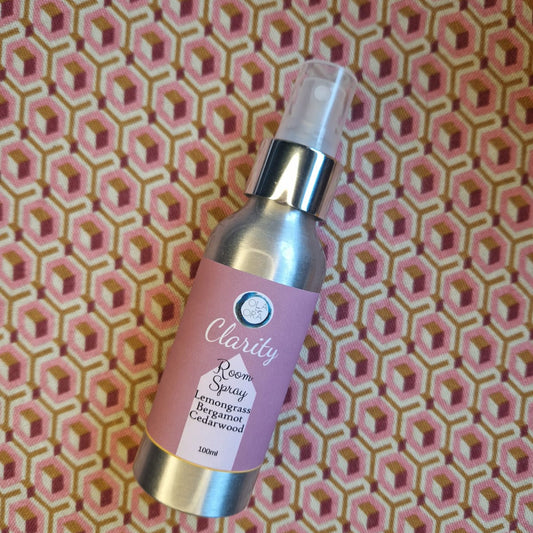 Aromatherapy Room Spray bottle labeled 'Clarity' on a pink geometric patterned background