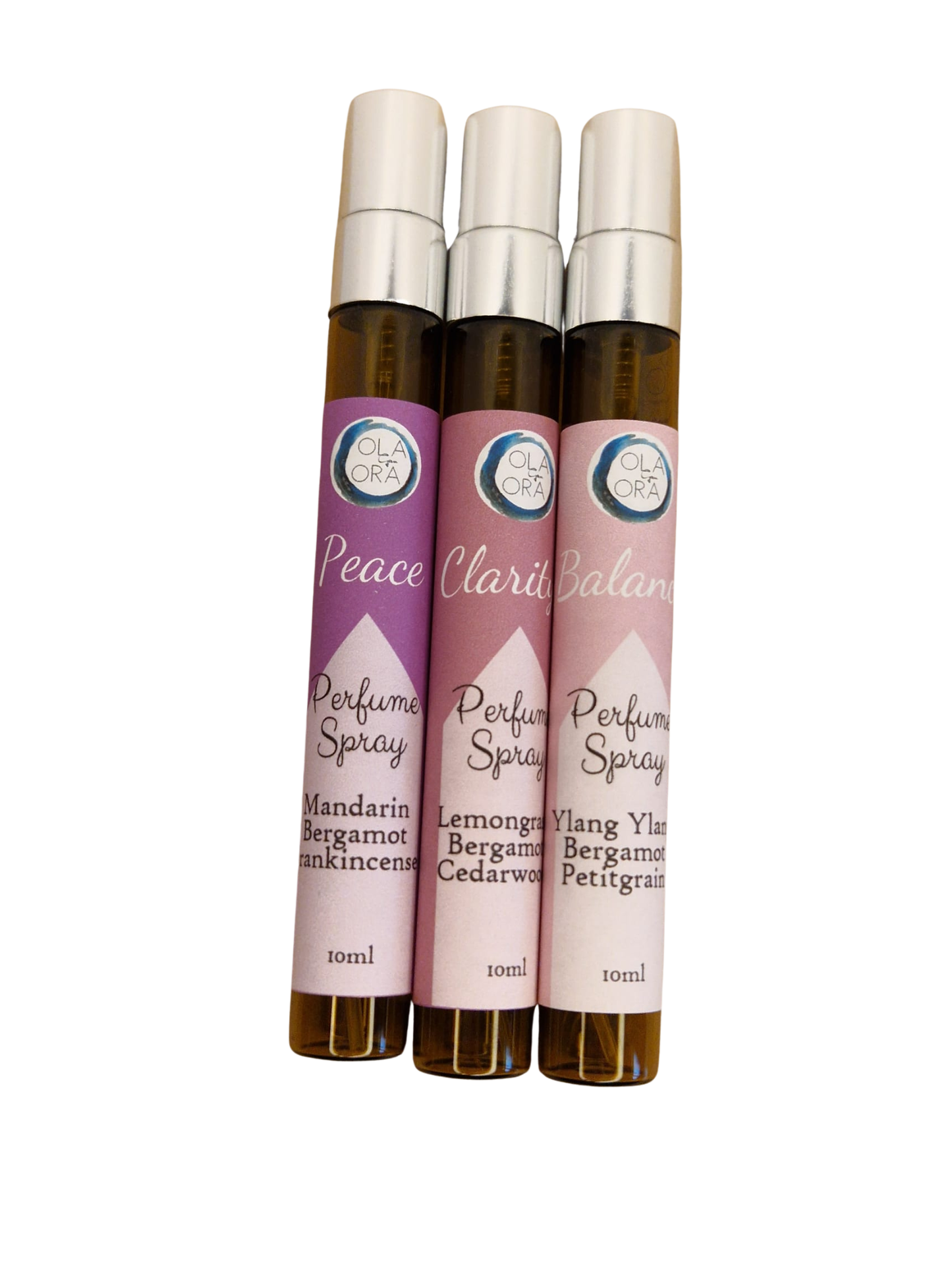 Three amber glass perfume spray roller bottles with silver caps and pink labels, arranged side by side on a white background. The labels read Peace, Clarity, and Balance, with scent names including Mandarin Bergamot, Bergamot Cedarwood, and Yang Yin Bergamot Perfum.