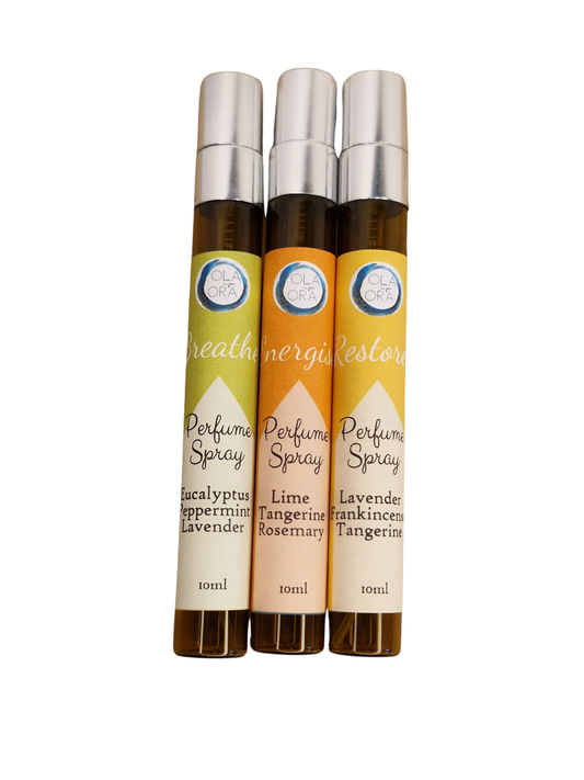 Three 10ml perfume spray roller bottles lined up vertically. The bottles are amber brown with silver caps, and the labels feature different color blocks: yellow-green, orange, and cream, with white script text reading 'creativity store' and 'Perfume Spray'.